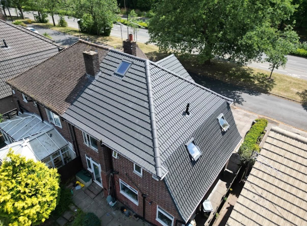 The same semi-detached house after re-roofing with new grey tiles, rebuilt chimney, new rooflights and fascias