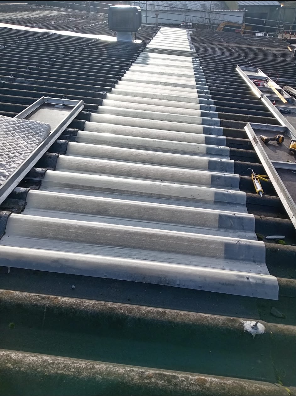 New translucent skylight sheets being installed on an industrial roof
