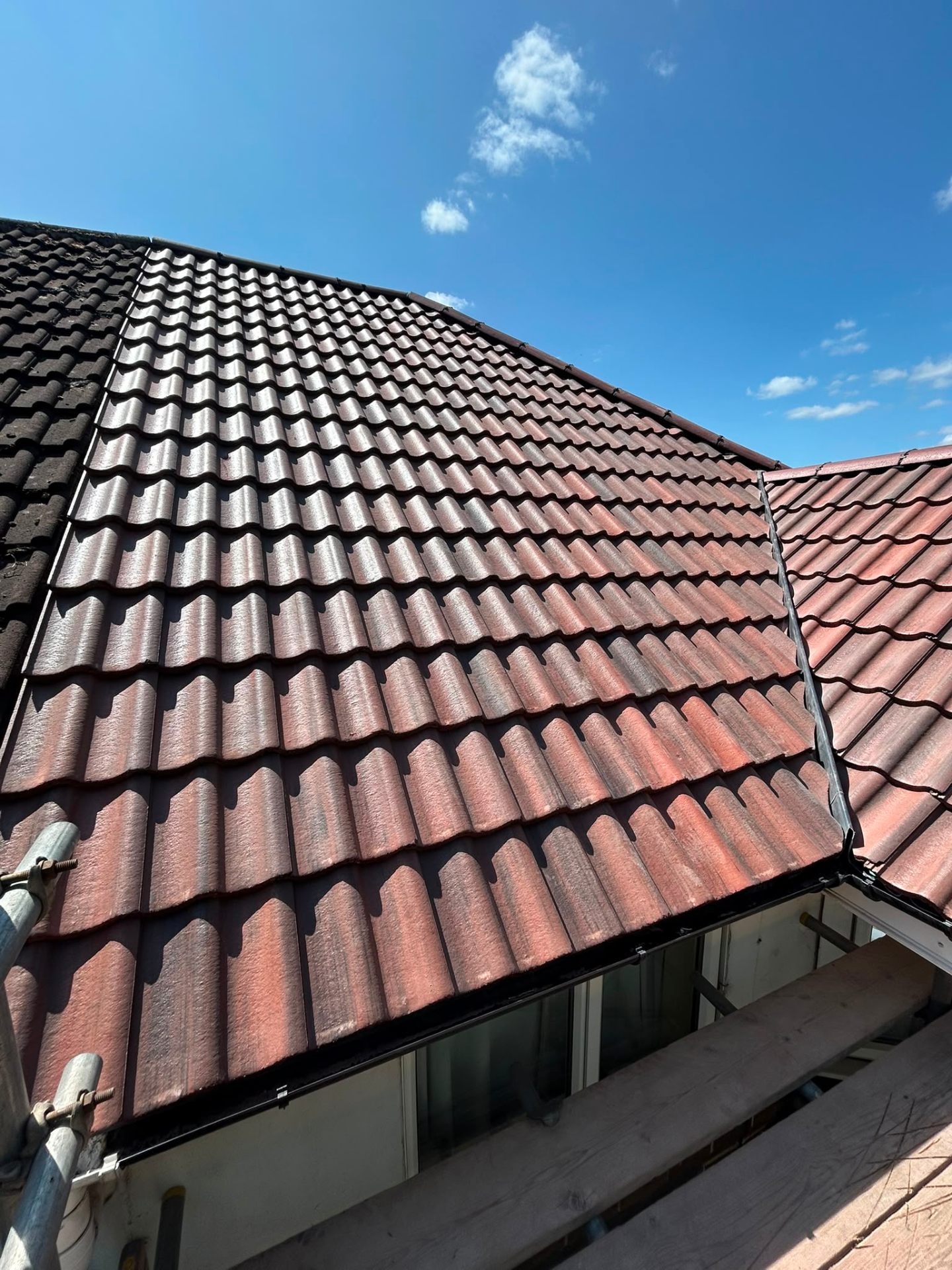 Close-up of new red-brown pantile roof installation on a Coventry property