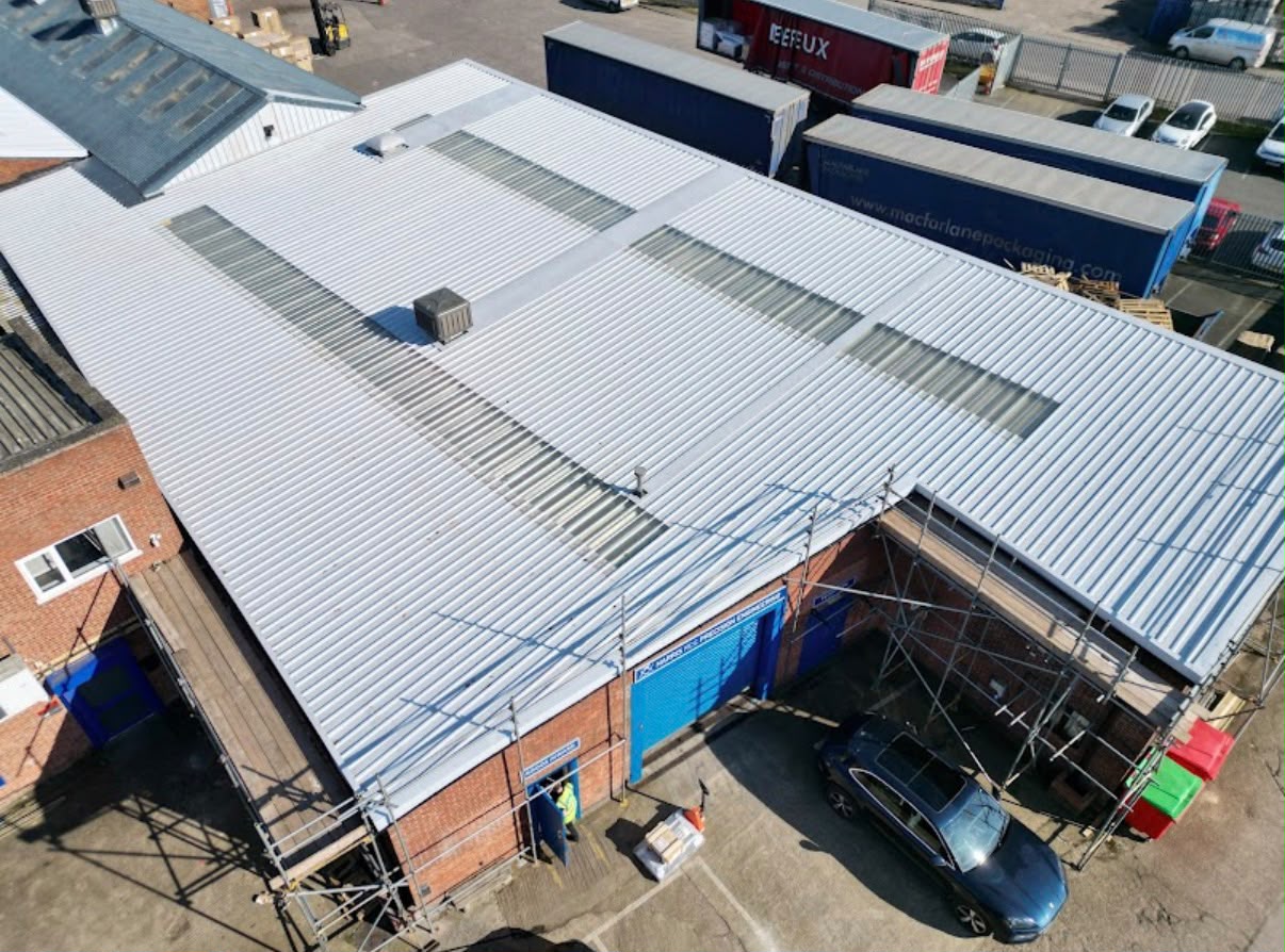 Newly completed industrial roof with silver profiled metal sheets
