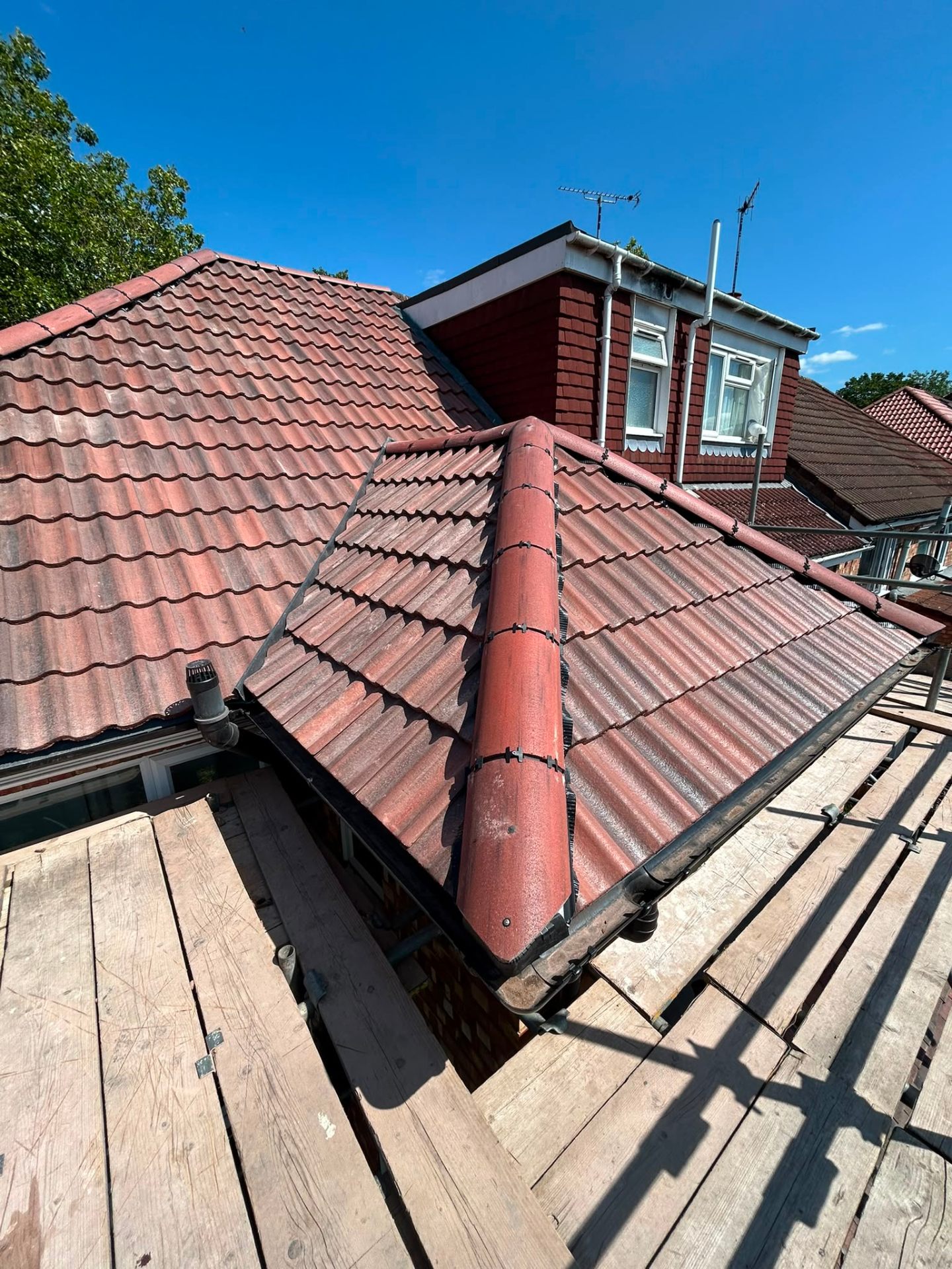Newly tiled dormer and valley detail on a residential re-roof project